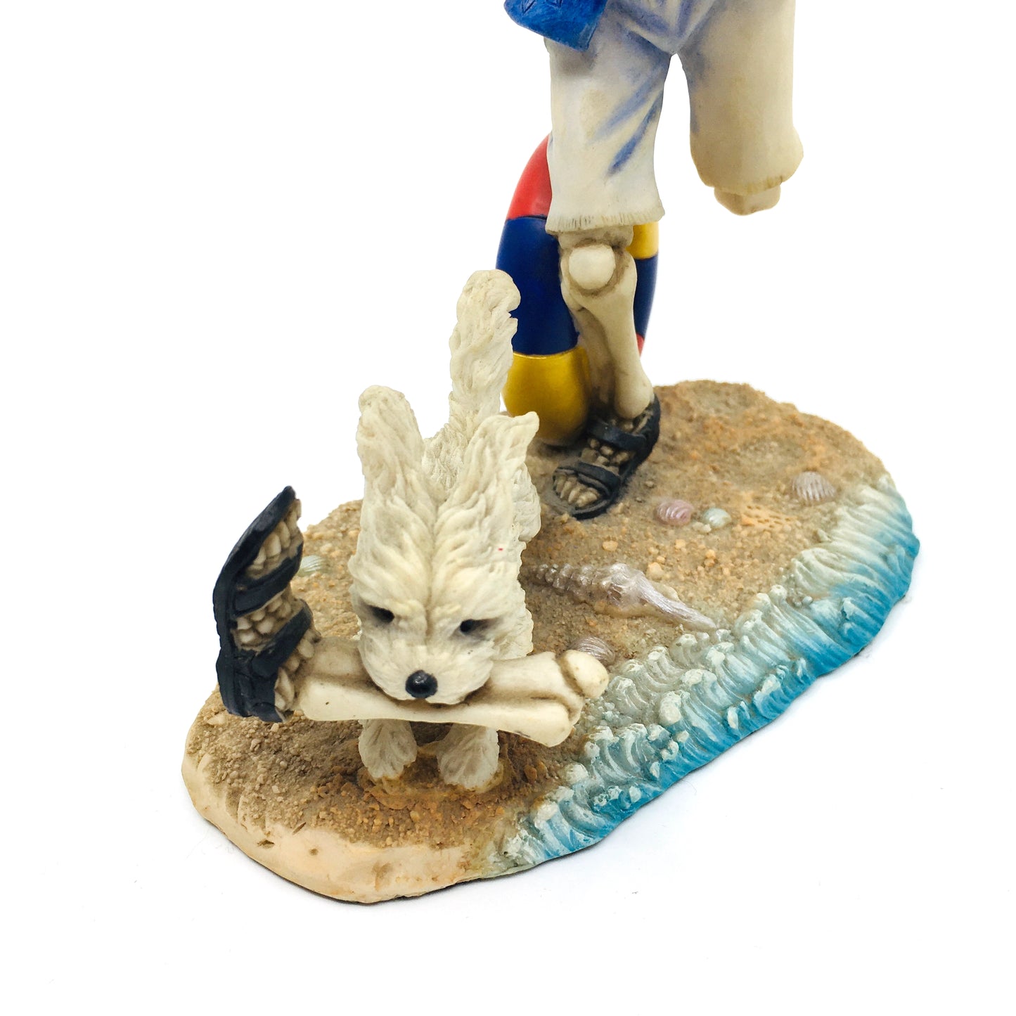 Skeleton Beach Man Making Fetch for His Dog Figurine